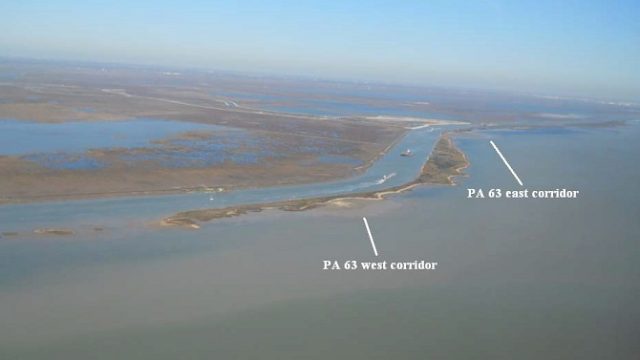 Aerial view of coastal marsh and navigation channels at PA 63, with narrow constructed shoreline areas surrounded by open water. Labels and arrows identify the PA 63 east and west corridors.