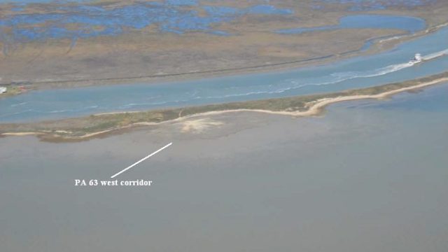 Aerial view of PA 63 West Corridor showing a narrow constructed shoreline between open water and a navigation channel, with extensive marsh habitat beyond. A label and arrow identify the PA 63 west corridor.